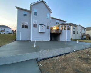 Back view of house with new concrete patio.