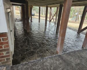 Stamped concrete patio under deck