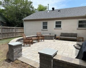 Backyard patio with wooden furniture near house.