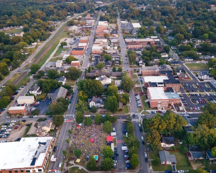 Aerial view of city district and park with event.