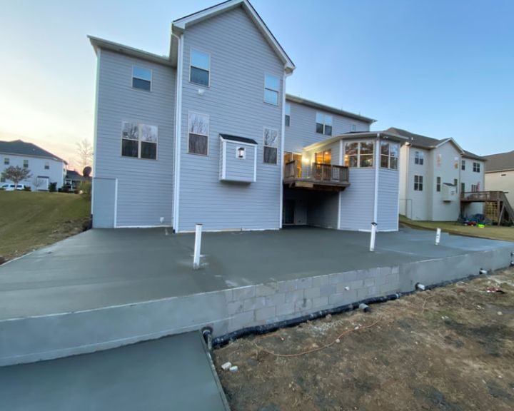 Back view of house with new concrete patio.