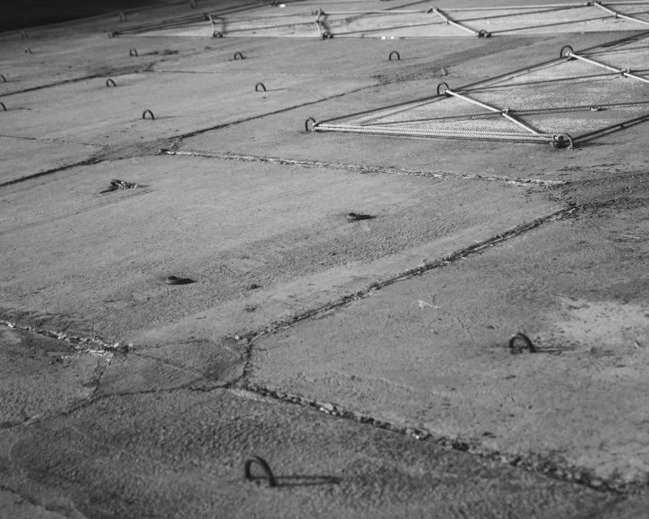 A monochrome snapshot featuring a City's concrete floor.