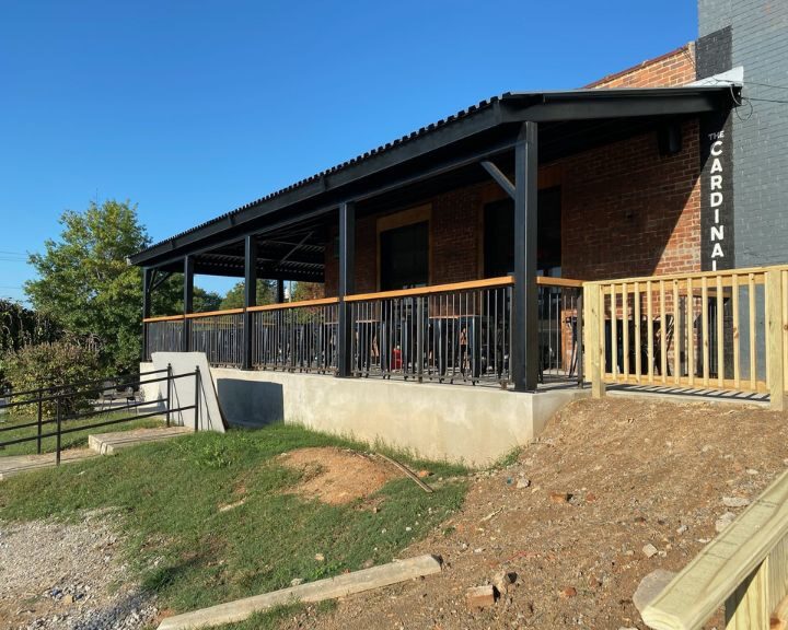 Outdoor patio with metal railing on a sunny day.
