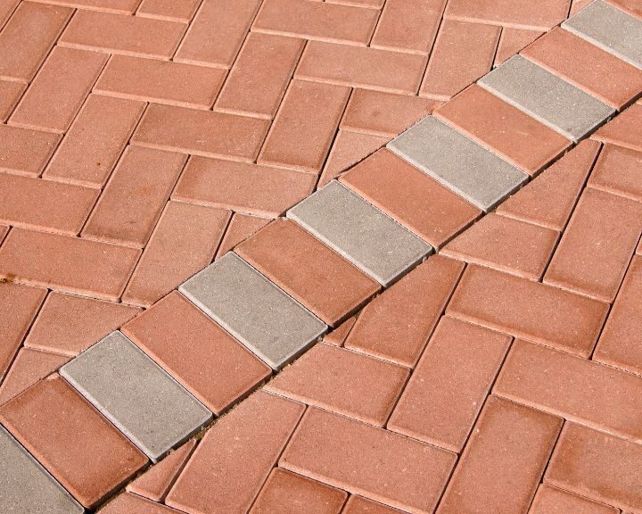 A close up of a red brick walkway in the city.
