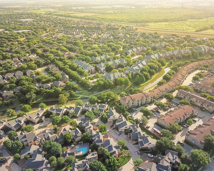 Aerial view of suburban neighborhood with houses and trees.
