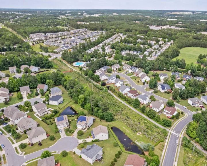 Aerial view of suburban neighborhood with houses and roads.